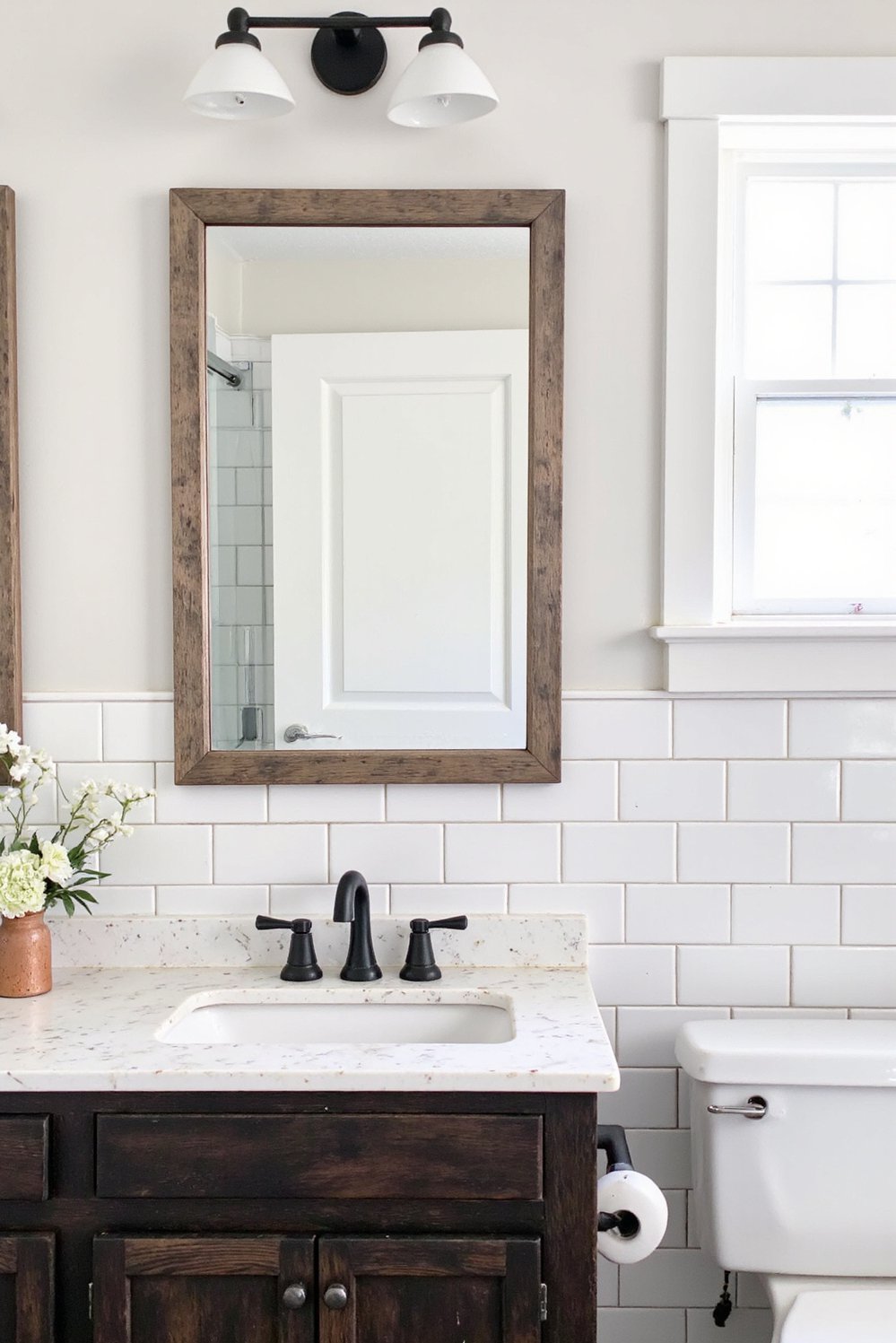 Modern Farmhouse Color Palette - Modern Farmhouse Bath: White Tile & Black Accents - Modern farmhouse bathroom design. Crisp white subway tiles,...