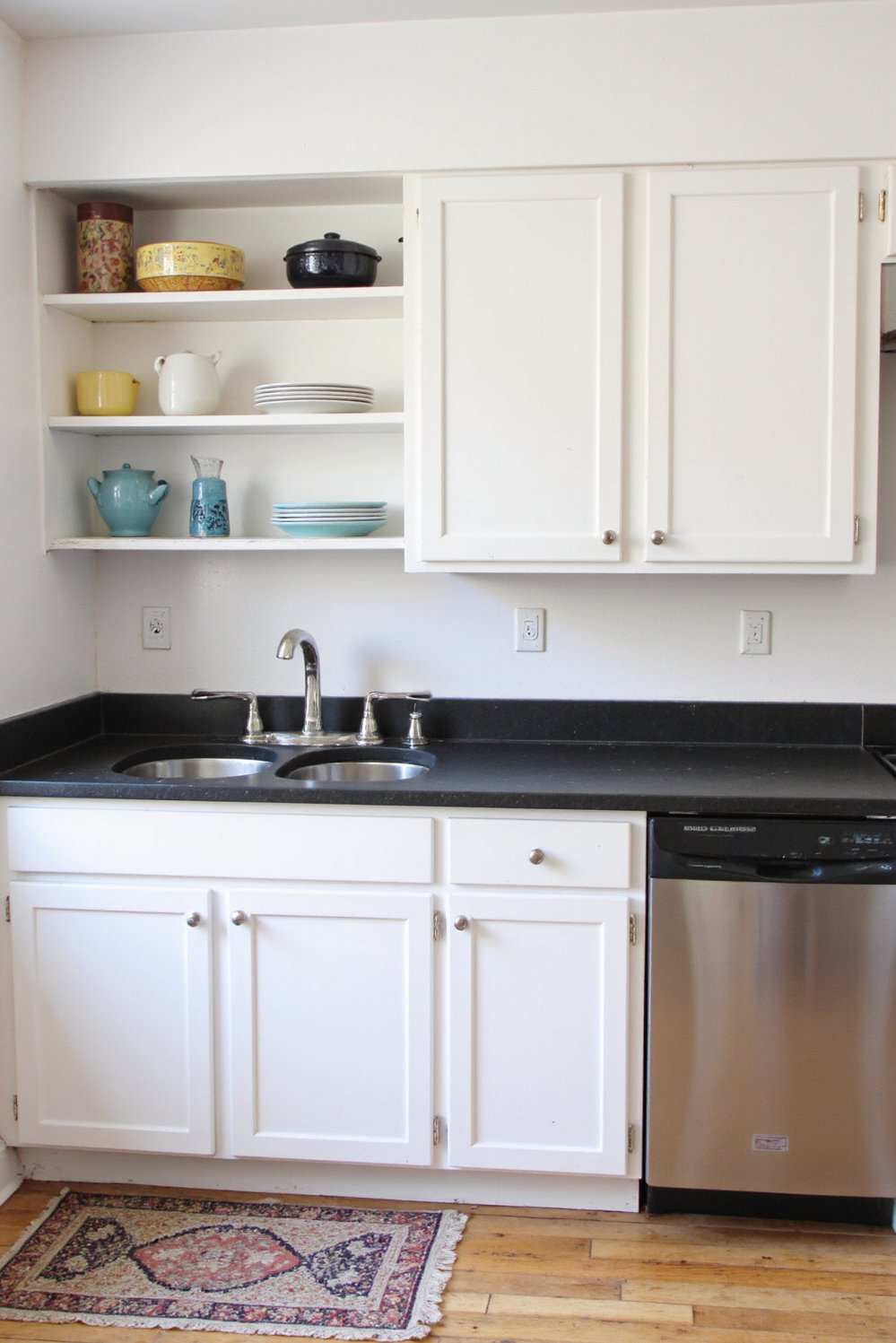 Black and White Modern Kitchen - Cozy White Kitchen: Black Countertops & Shaker Cabinets - Cozy small white kitchen with black countertops. I...