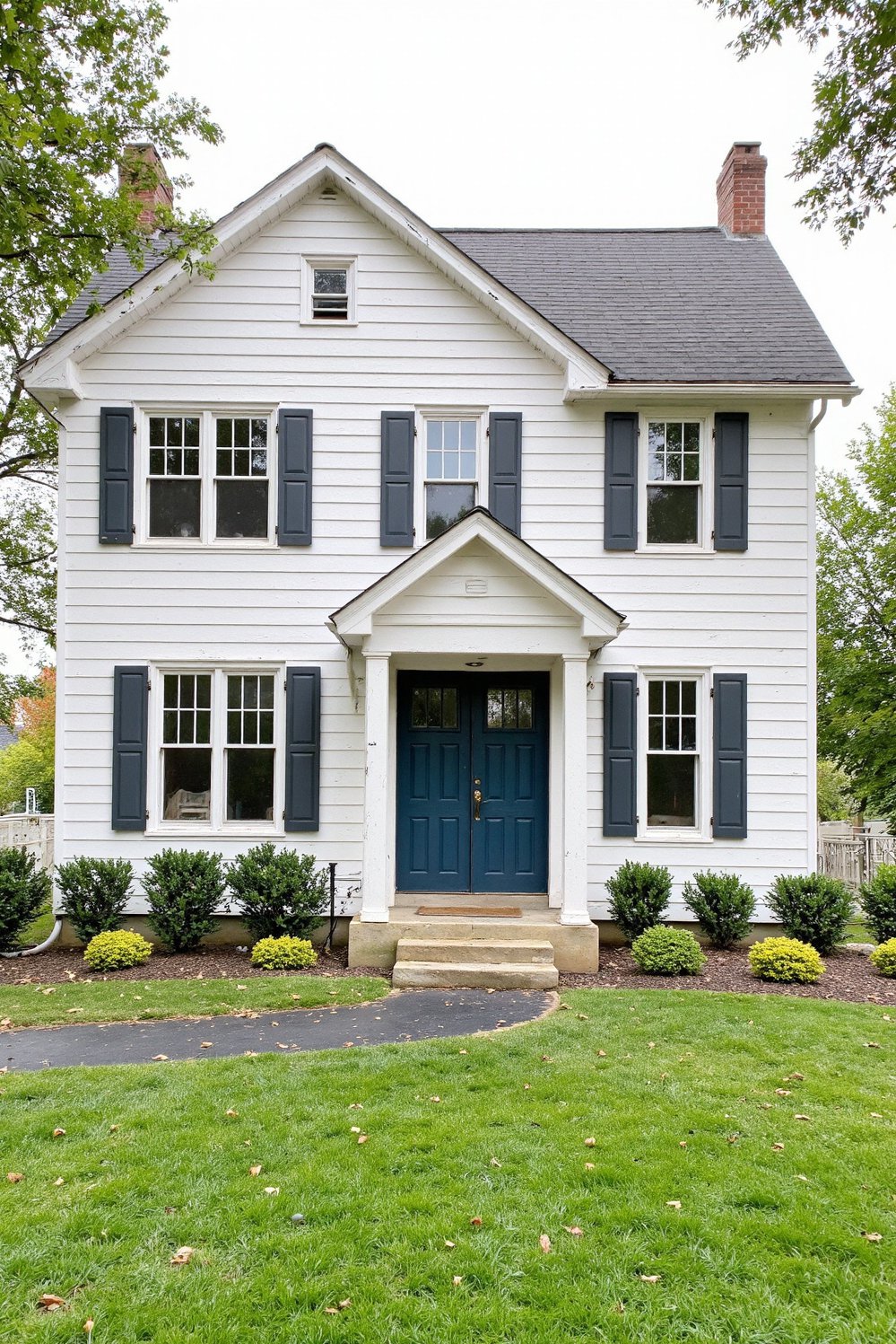 Modern Farmhouse Color Palette - Farmhouse Exterior: White, Grey & Teal Palette - Classic modern farmhouse exterior. White clapboard siding, charcoal...