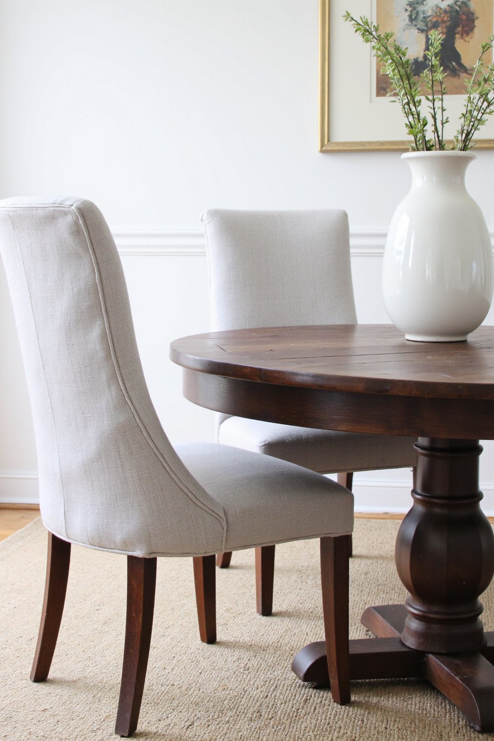 Neutral upholstered dining chairs - Pale Gray Linen Dining Chairs: Dark Wood Contrast - Two pale gray linen dining chairs sit at...