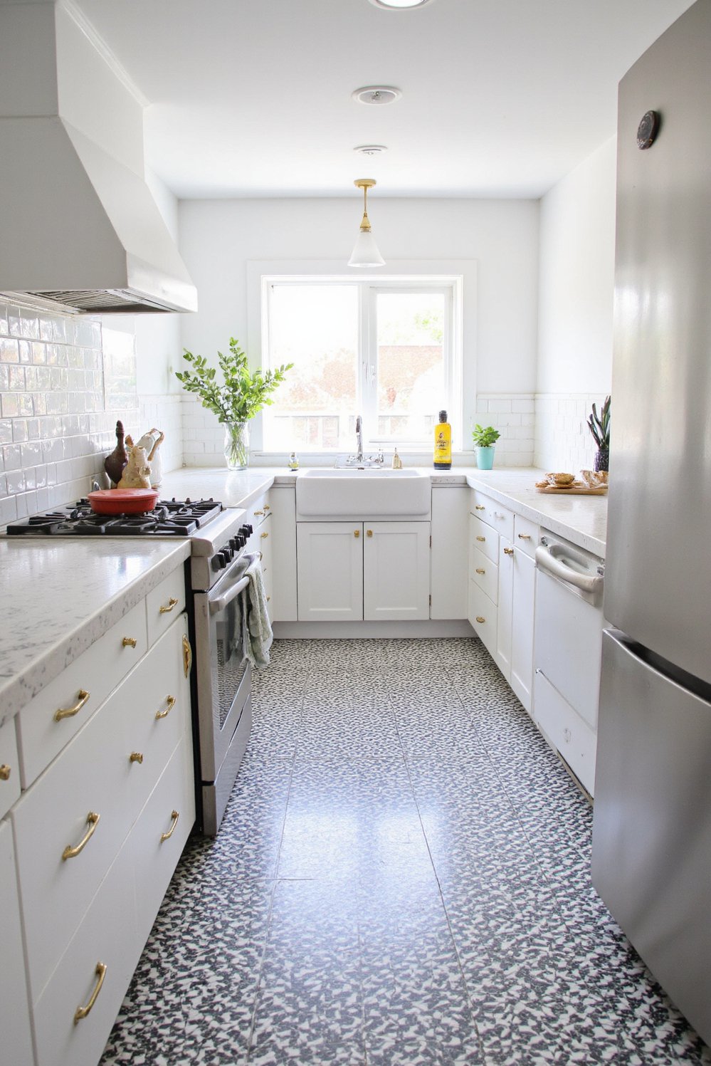 Black and White Modern Kitchen - White Kitchen Design: Black & White Patterned Floor - Modern white kitchen with a bold black and...