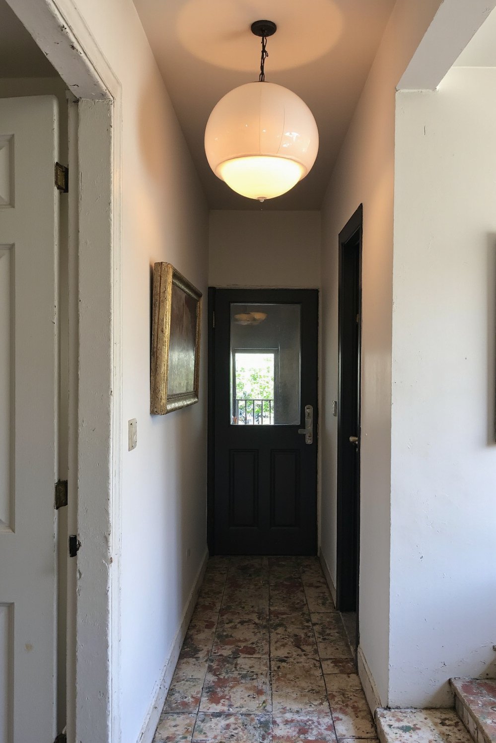 Narrow hallway decor ideas - Dramatic Lighting: Brighten a Dark Narrow Entryway - Small entryway? A dramatic pendant light is key!...