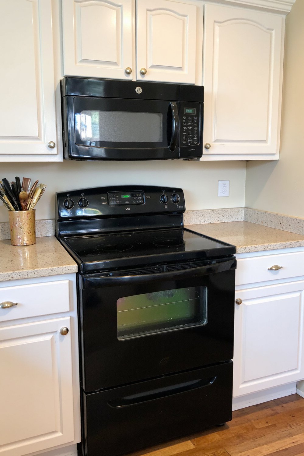 Black and White Modern Kitchen - Small White Kitchen with Bold Black Appliances - Small white kitchen with black appliances. Simple white...