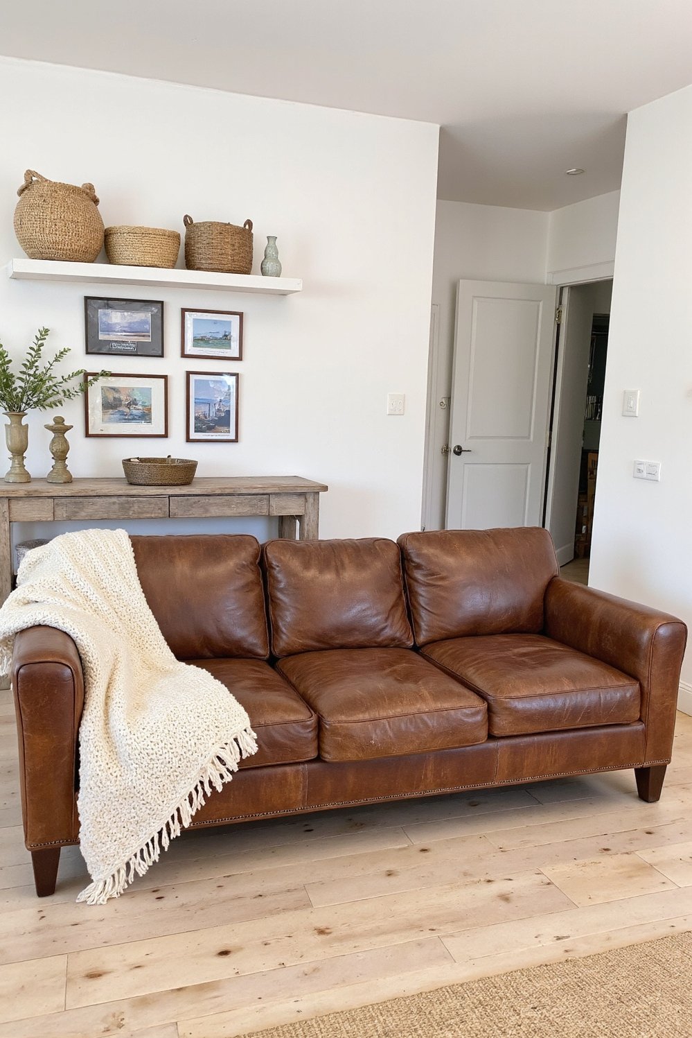 beachy living room ideas - Coastal Casual Living Room with Worn Leather Couch - Coastal living room with a relaxed vibe. I...