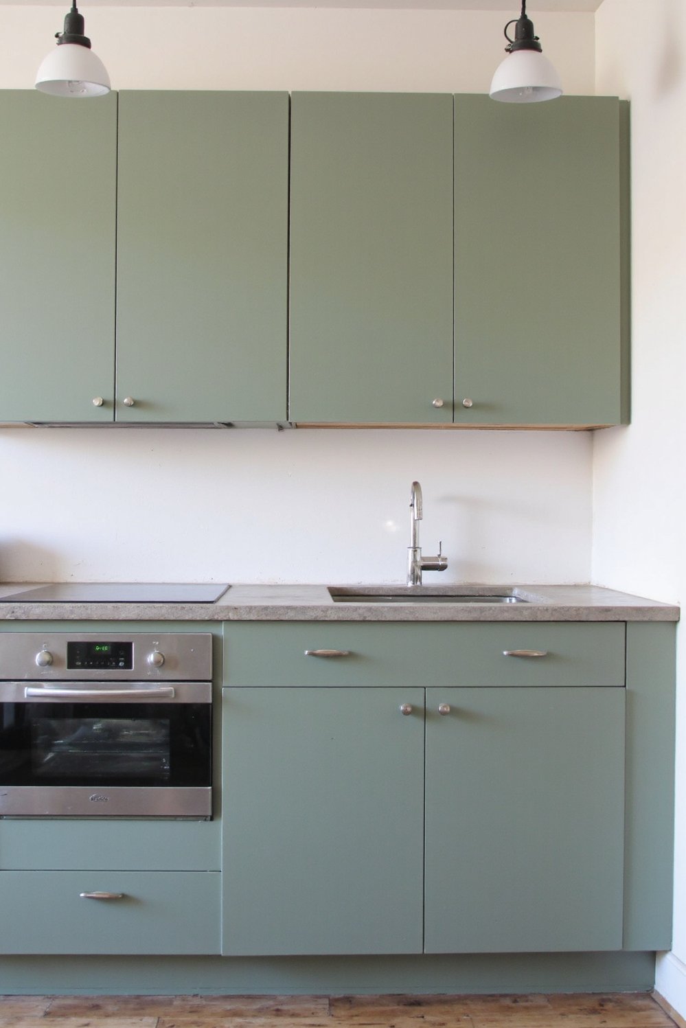 Sage Green Home Decor Ideas - Sleek Sage Green Kitchen: Handleless Cabinets & Concrete - Sleek sage green kitchen! Muted green cabinets are...