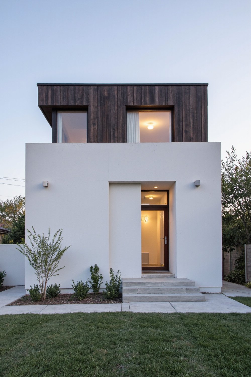 Modern house exteriors - Modern Exterior: White Concrete & Dark Wood Contrast - Modern two-story house: striking contrast of white concrete...