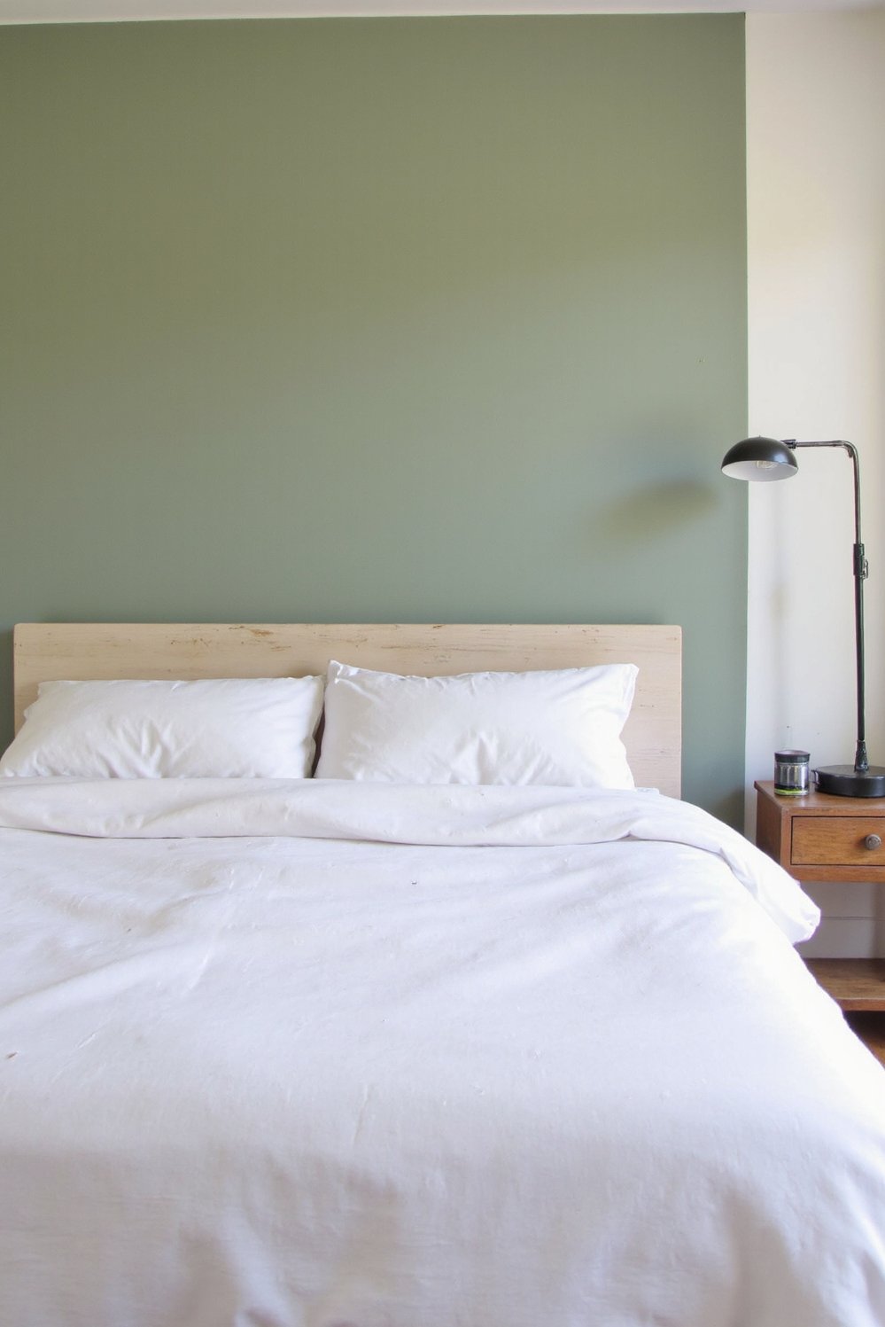 Sage Green Home Decor Ideas - Minimalist Sage Green Bedroom with White Bedding - Sage green minimalist bedroom. A single sage green...
