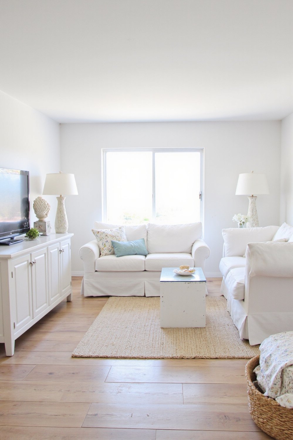 beachy living room ideas - Bright Modern Coastal Living Room with White Sofa - Modern beach living room ideas: This minimalist space...