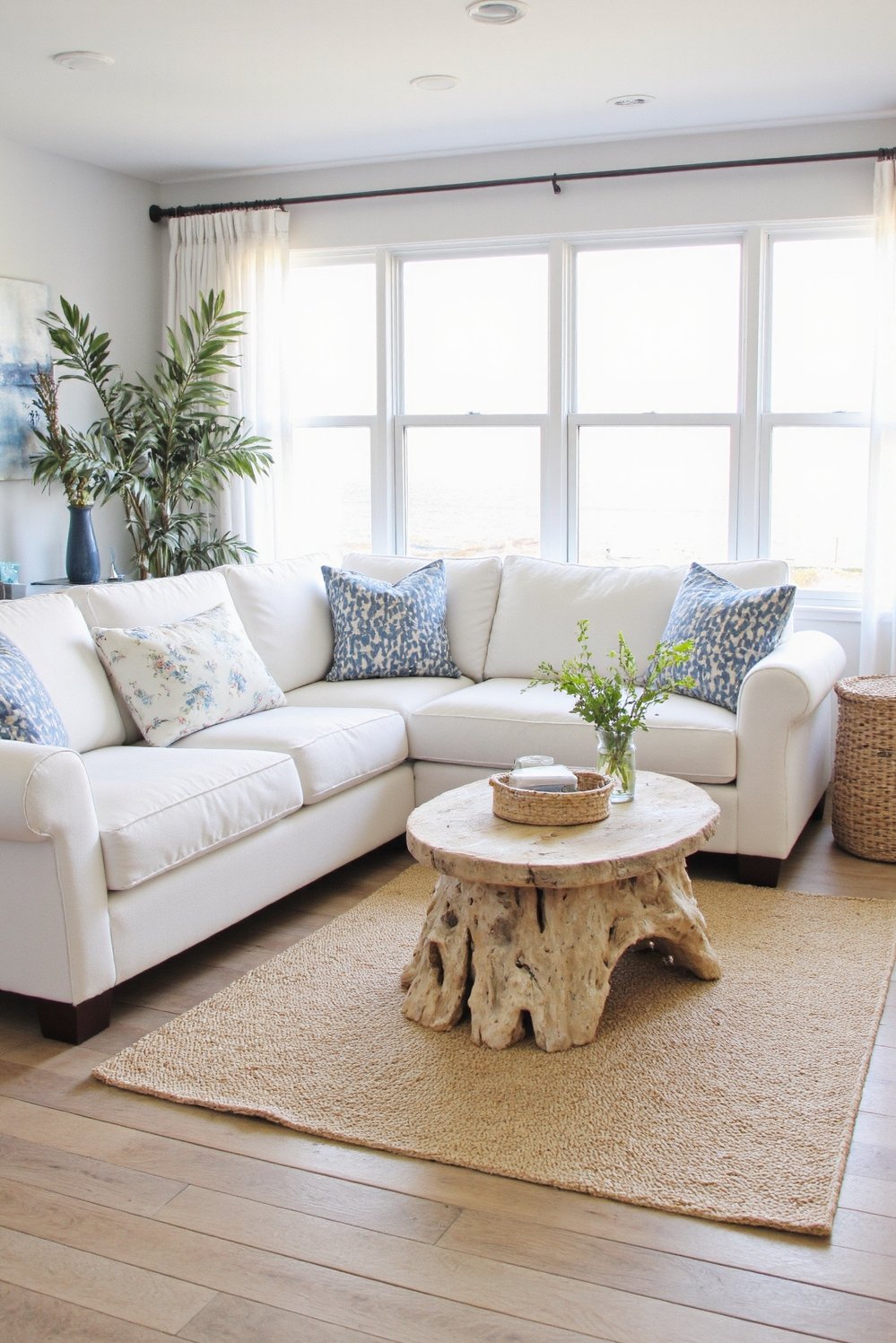 beachy living room ideas - Sun-Drenched Coastal Living Room with White Sofa - Bright, airy coastal living room. I love the...
