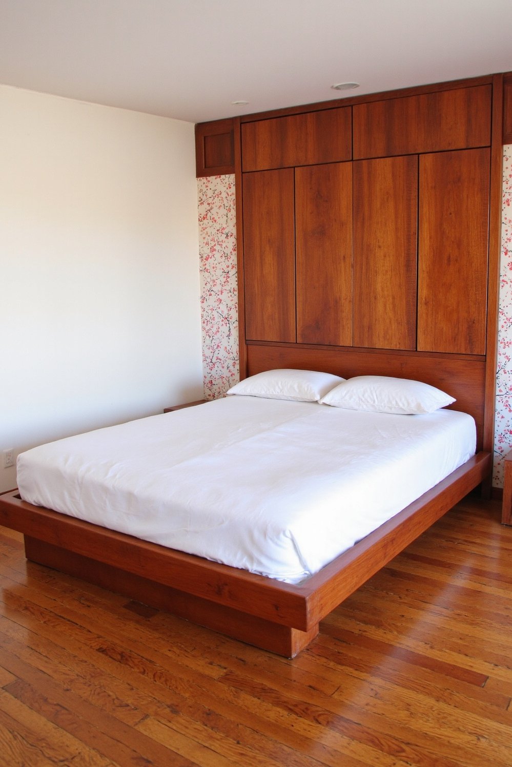 Cherry Bedroom Ideas - Minimalist Red Bedroom with Cherry Wood Accents - Modern red bedroom with sleek cherry wood furniture....