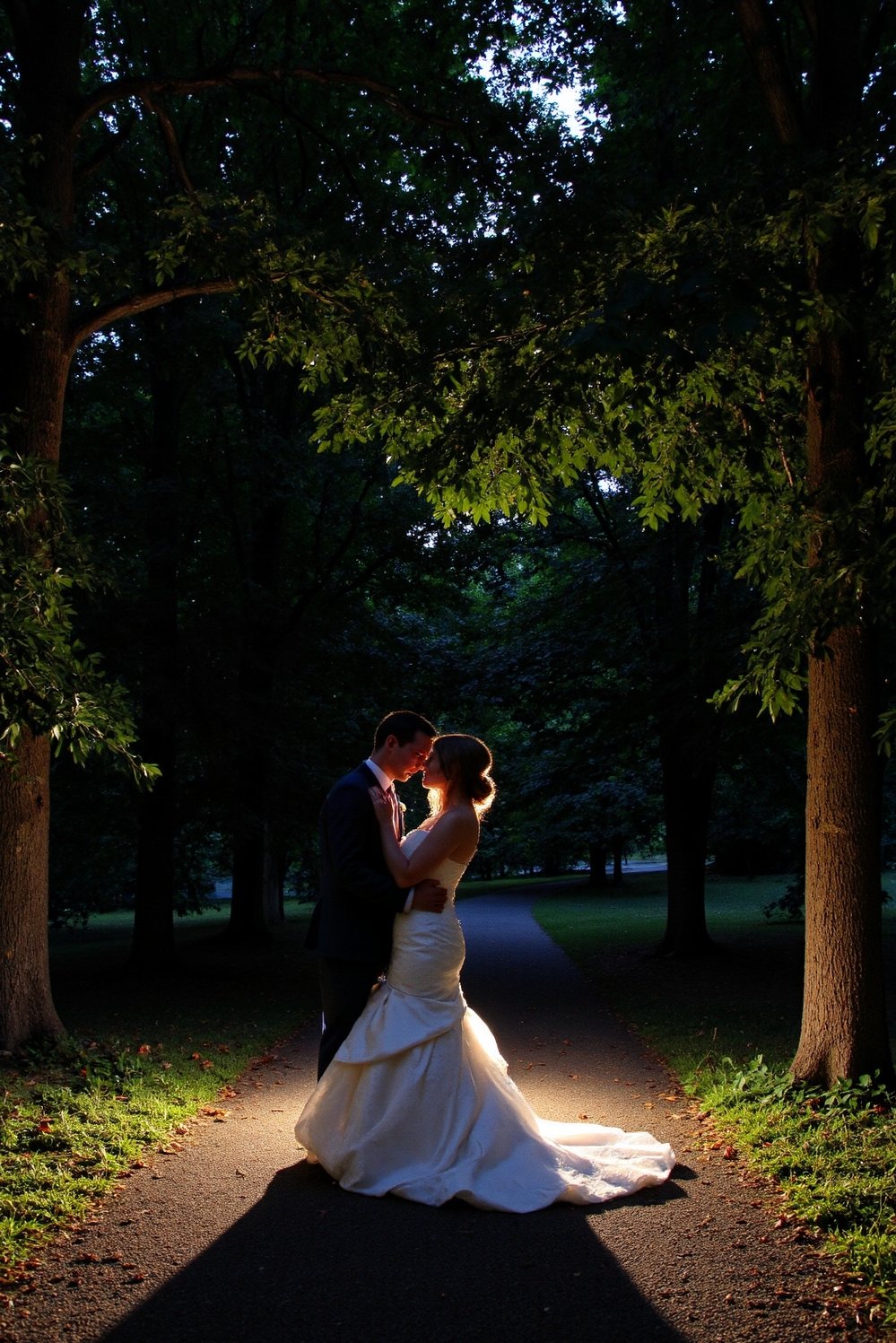 Moody Romantic Wedding Decor - Moody Romantic Wedding: Embrace Under Dark Trees - Romantic wedding photo: a dark, lush setting. The...