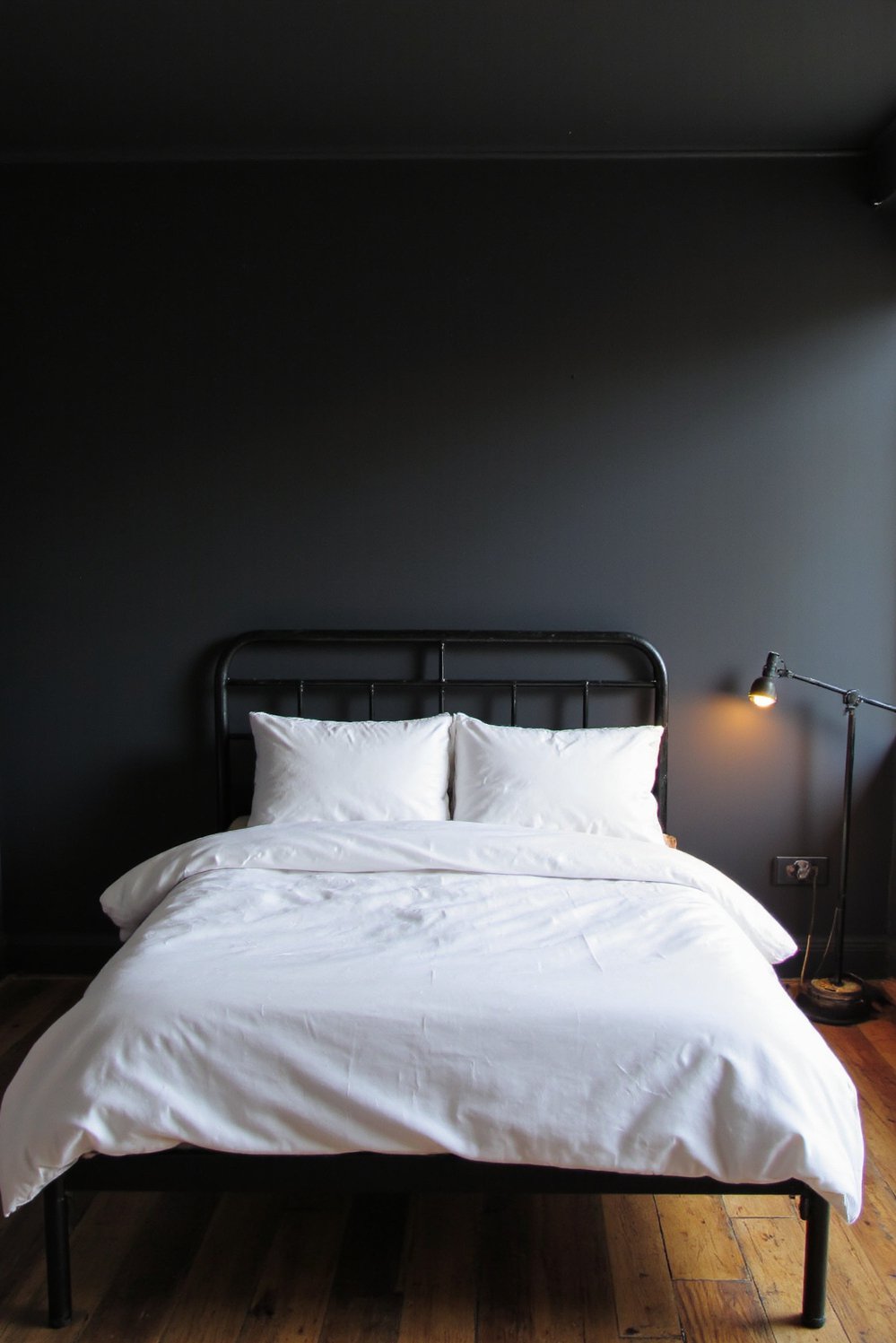 Tips for minimalist bedroom decoration - Moody Minimalist Bedroom: Dark Walls, Warm Glow - Dark walls, minimalist bedroom. This moody bedroom shows...