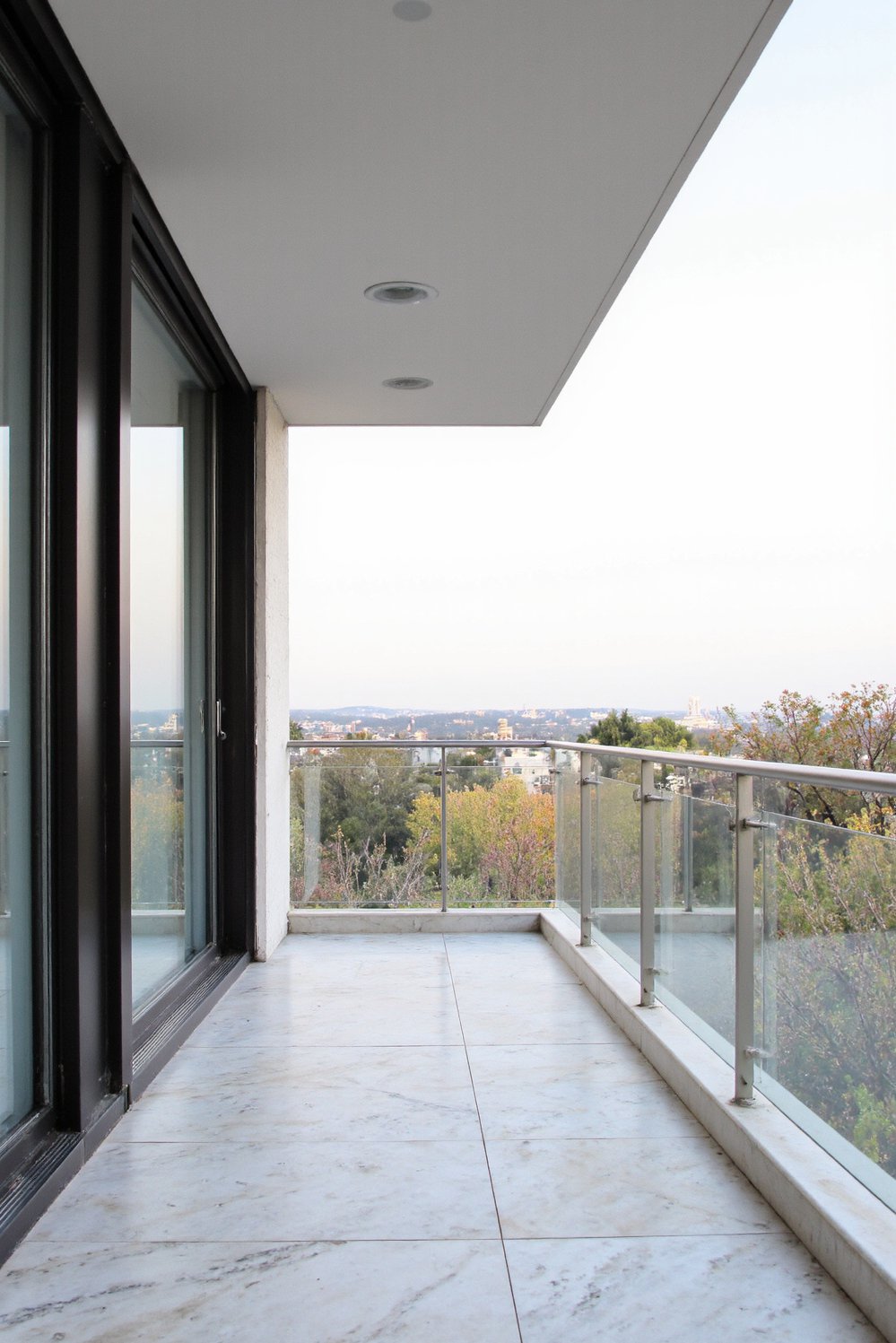 Balcony flooring ideas - Modern Balcony Design: Marble-Look Porcelain Tiles - Create a chic, modern balcony with large-format porcelain...