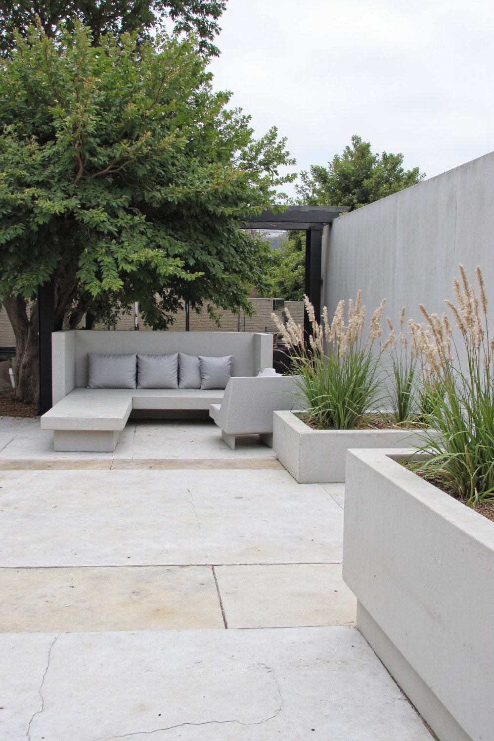patio furniture ideas - Modern Minimalist Patio: Concrete Sofa & Geometric Planters - Modern patio furniture ideas: This sleek concrete outdoor...