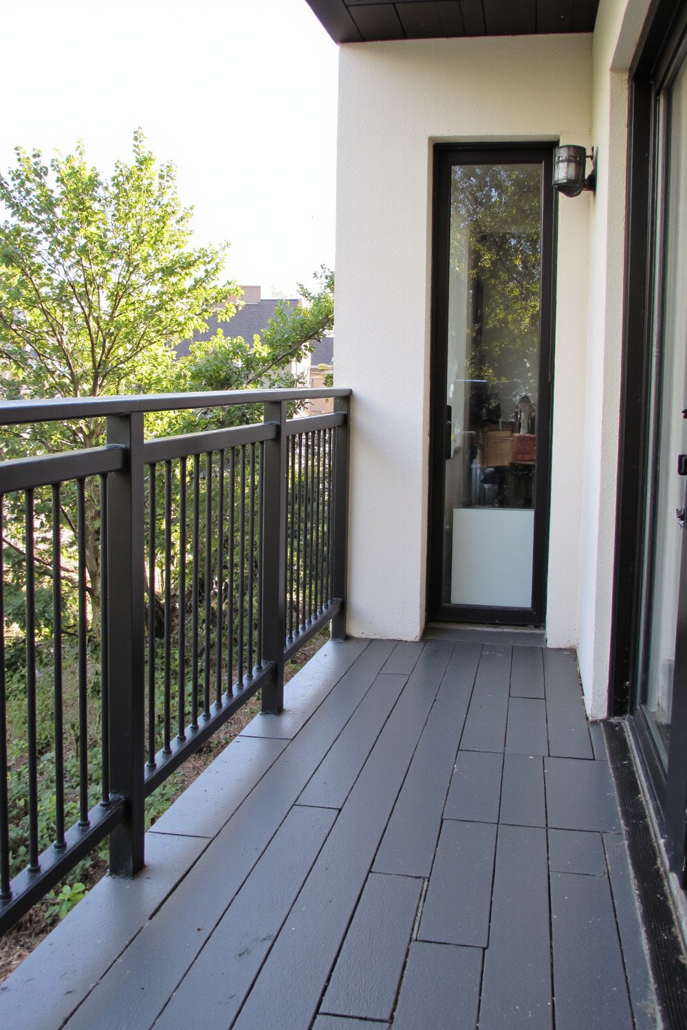 Balcony flooring ideas - Modern Balcony Design: Low-Maintenance Dark Grey Decking - This modern balcony boasts low-maintenance style. Dark grey...