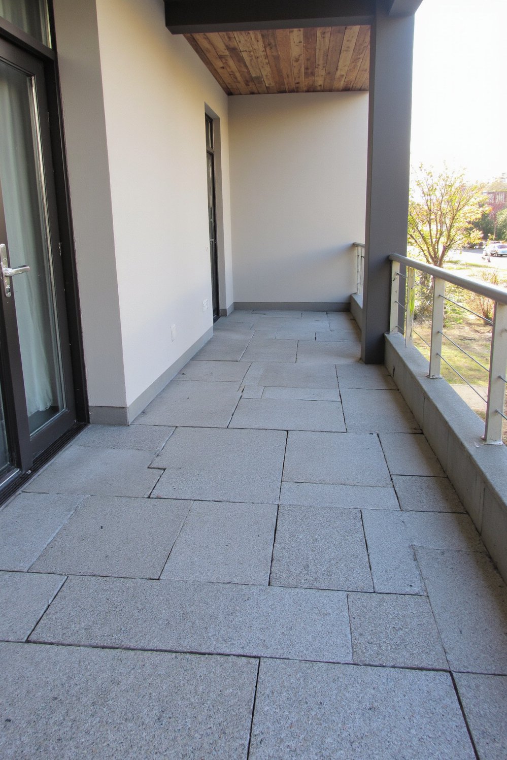 Balcony flooring ideas - Sleek Grey Pavers: Modern Balcony Flooring Ideas - Give your balcony a modern makeover with stylish...