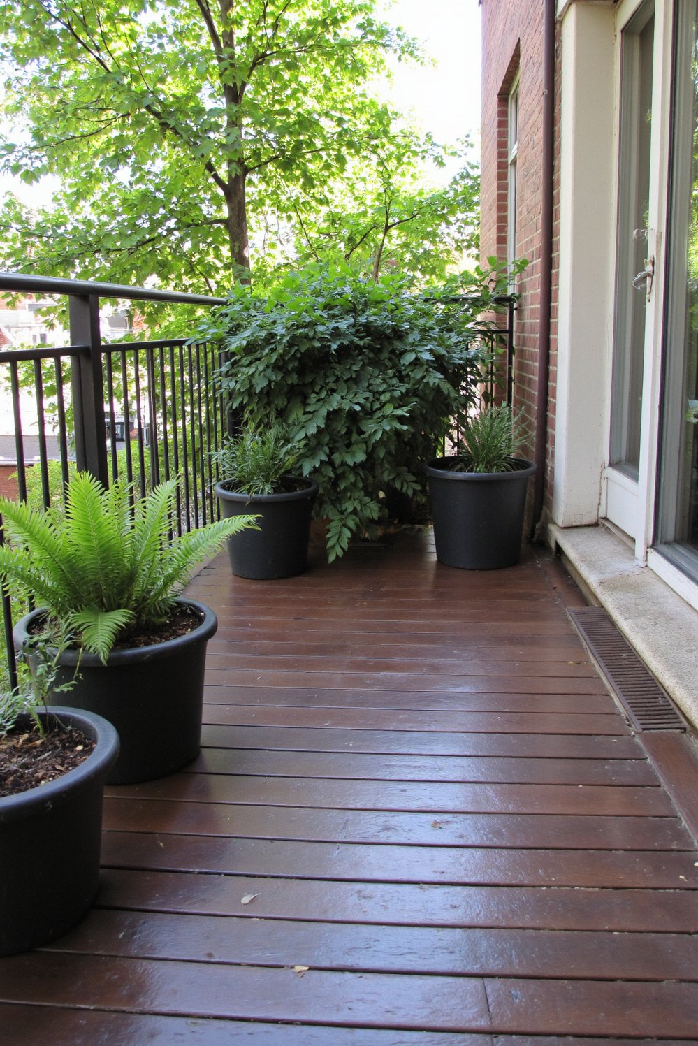 Balcony flooring ideas - Tranquil Oasis: Dark Wood Balcony Flooring - Create a tranquil balcony oasis with dark stained...