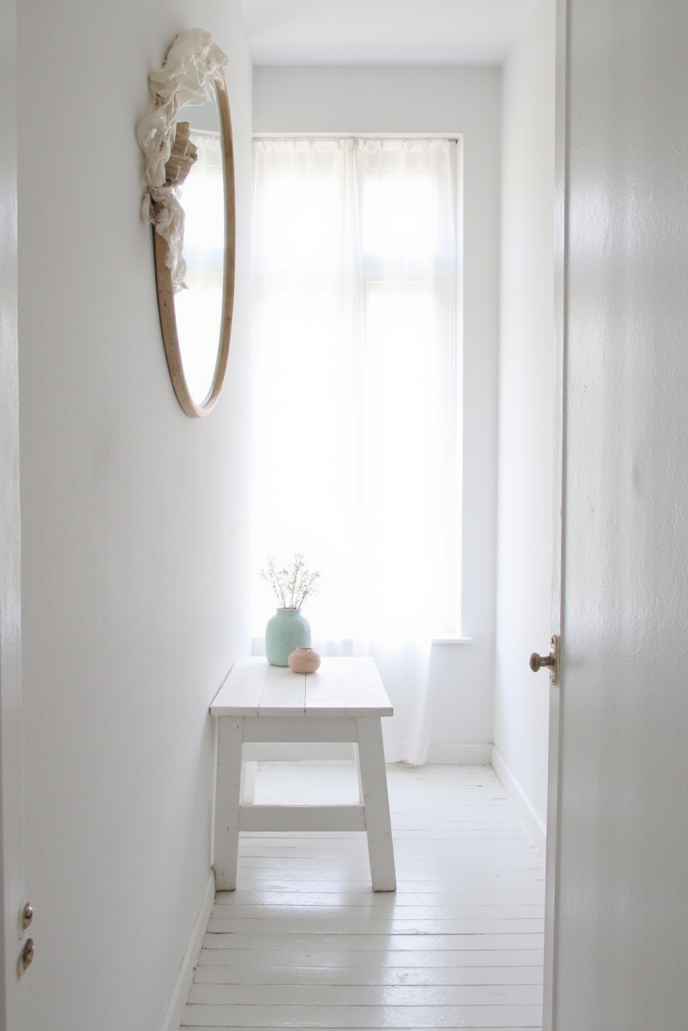 end of hallway decor - Scandi Light At Hallway's End - Crisp white walls stretch down a long hallway,...