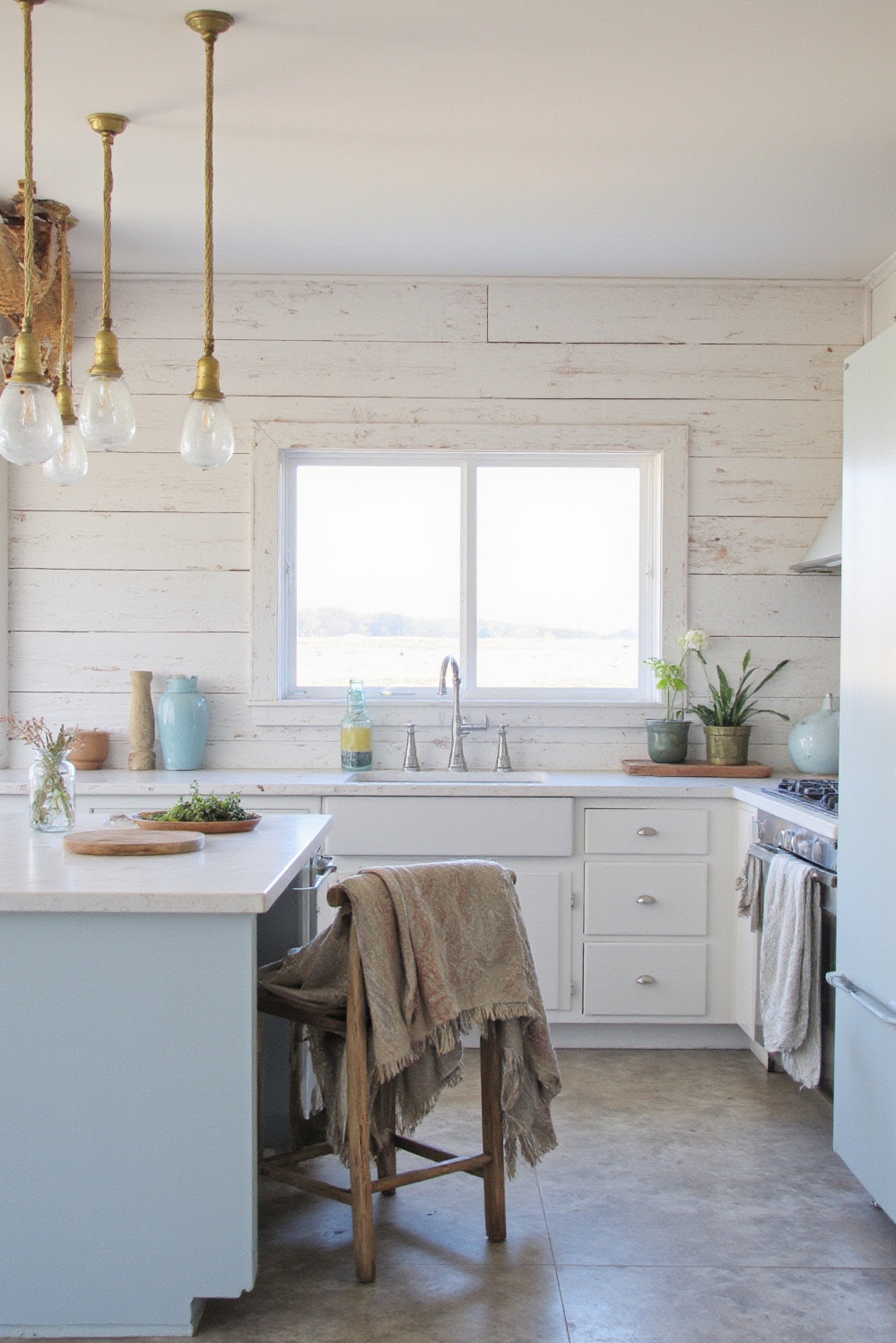 Industrial kitchen design - Coastal Industrial: Light & Serene - Sunlight streams into this coastal-industrial kitchen, instantly lifting...
