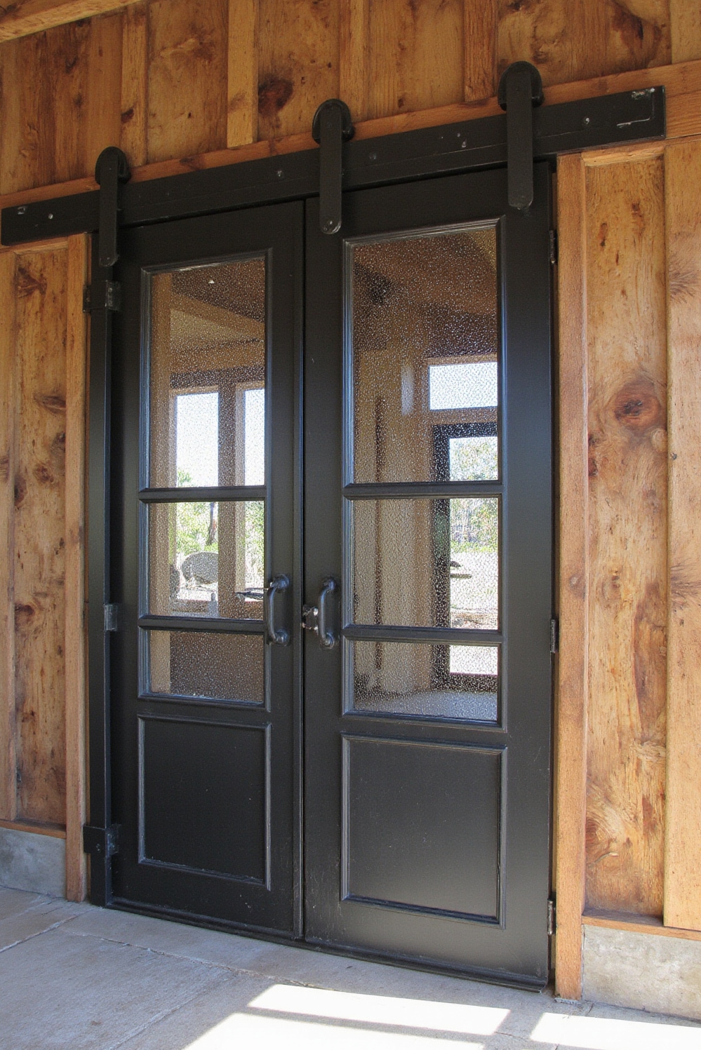 modern barn house - Grand Barn Door Entrances - The eye immediately catches a massive sliding barn...