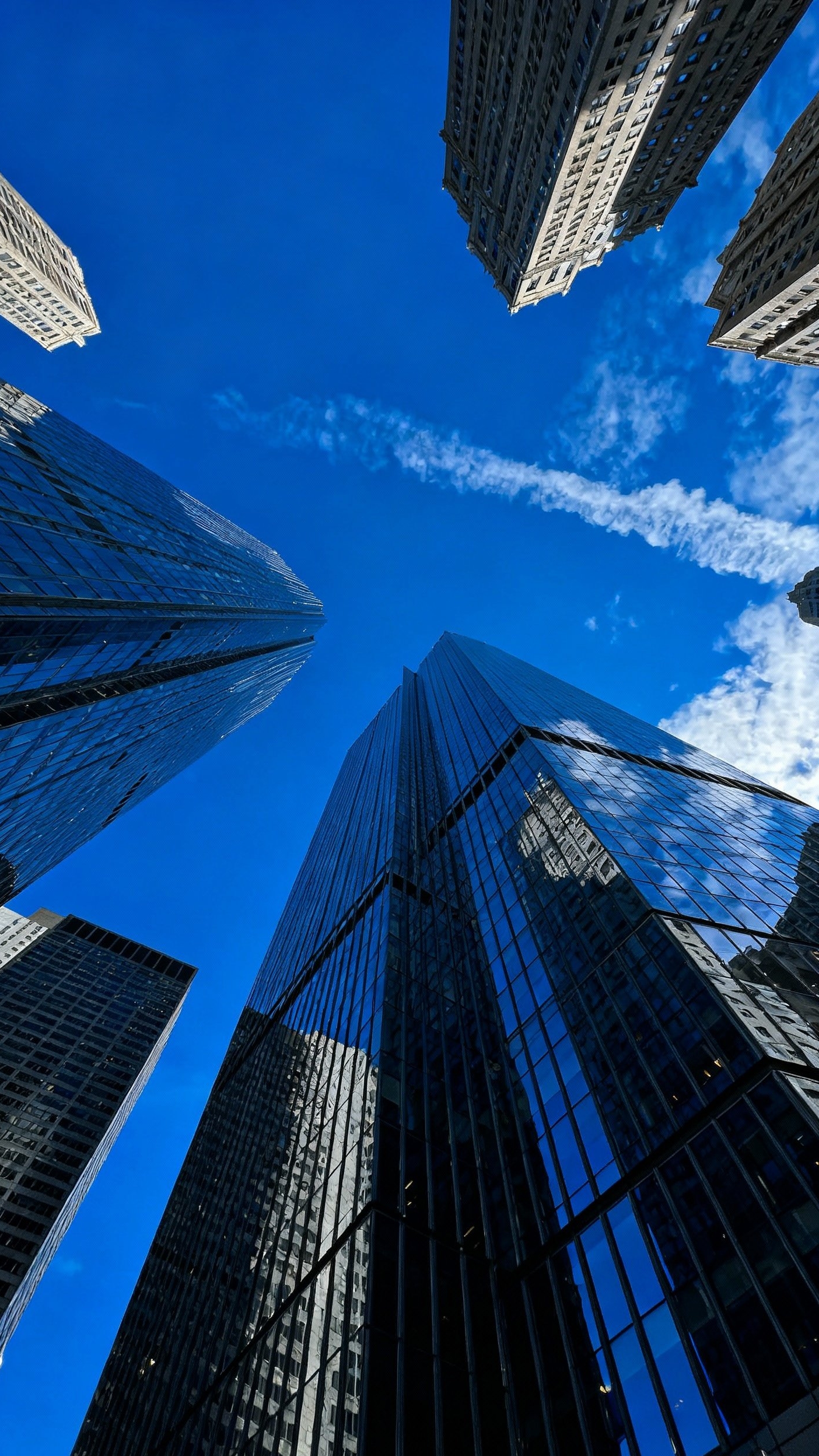 Urban City Photography - City Giants: Capturing Urban Power - The camera tilts skyward, capturing a dramatic perspective...