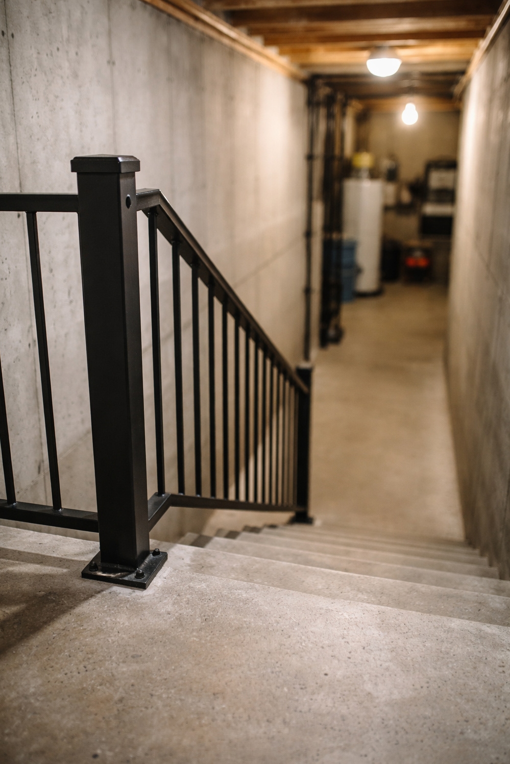 Black metal stair railings - Stark Contrast: Black Railings Against Concrete - These black metal stair railings offer stark contrast...