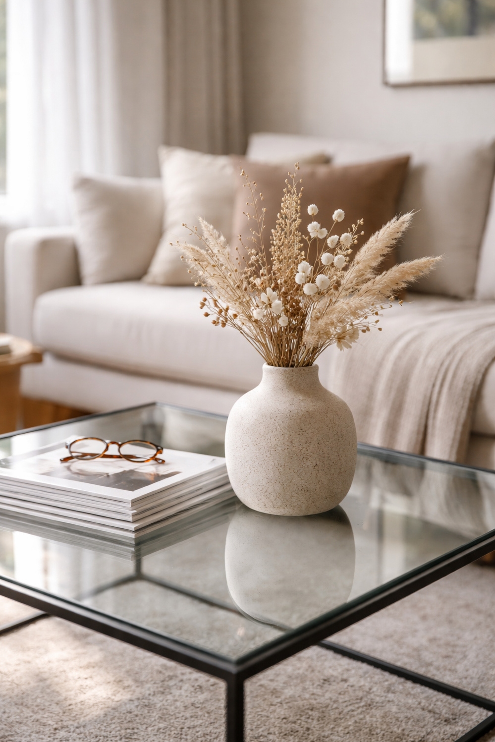 living room modern decor aesthetic - Glass Coffee Table Anchors Modern Look - The glass and metal coffee table anchors this...